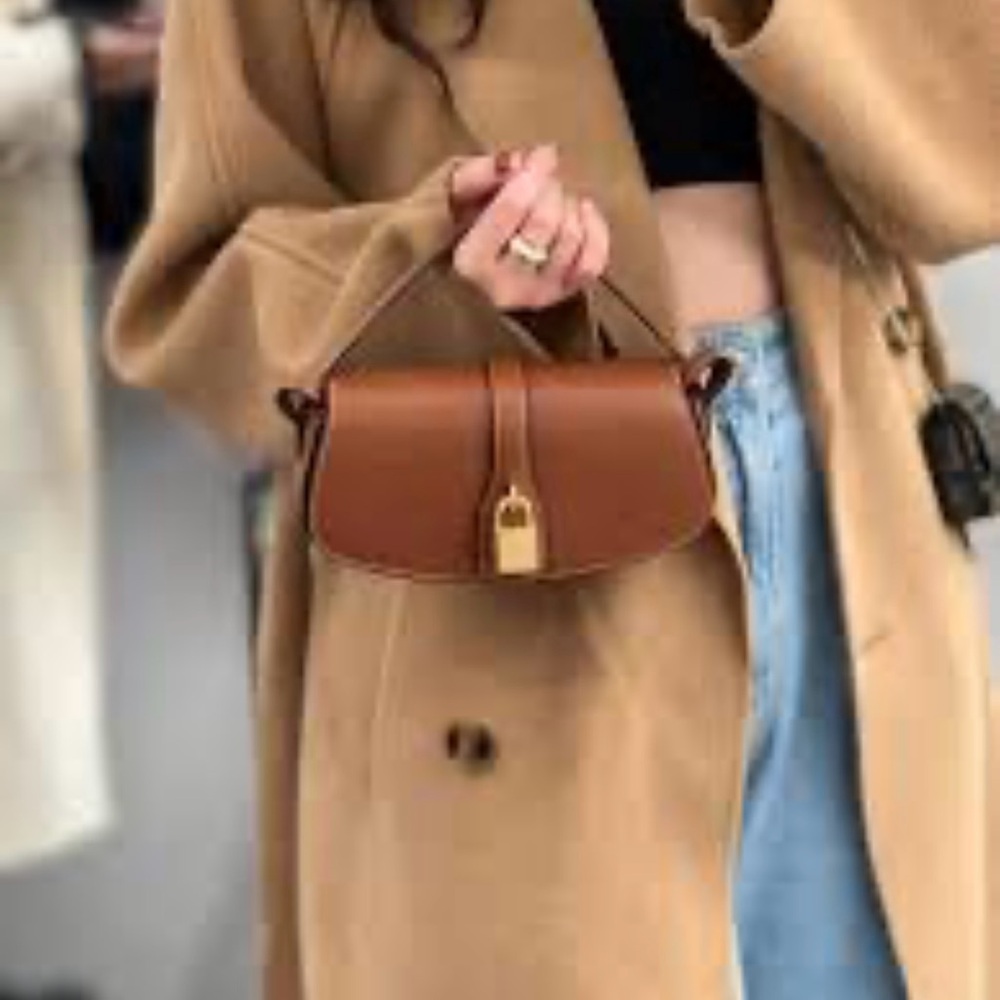 CÉLINE TABOU clutch on strap TAN